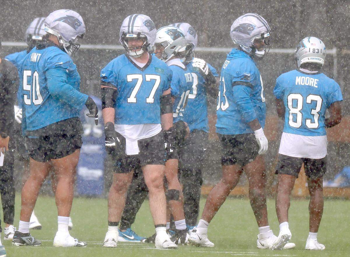 Carolina Panthers center Luke Fortner waits to begin a series of plays during a downpour at the team's first open workout on Tuesday, May 26, 2026.