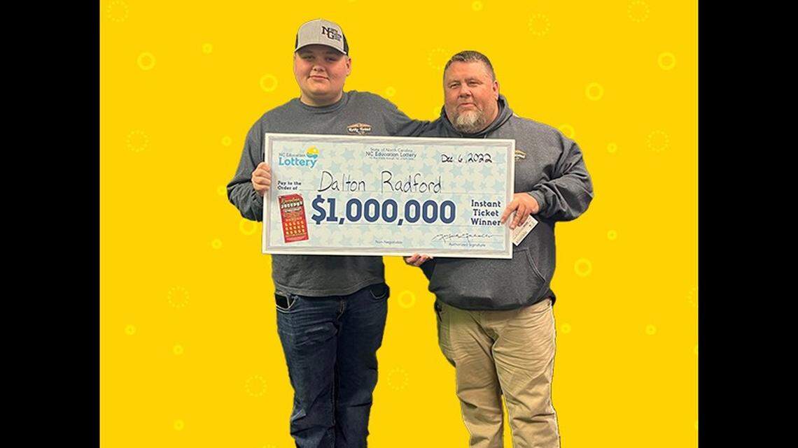 Dalton Radford, at left, poses with his father, Tim Radford, at N.C. lottery headquarters in Raleigh where he claimed his $1-million jackpot.