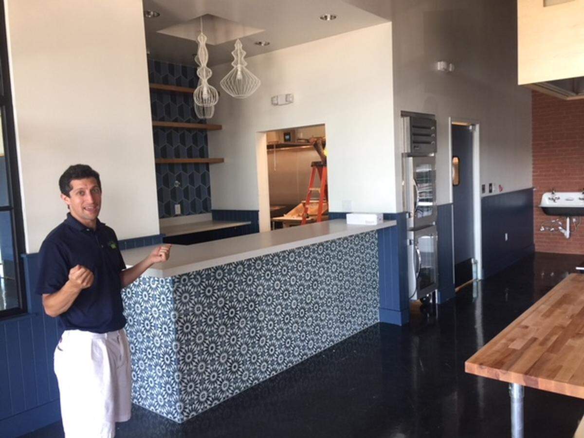 Co-owner Andrew Wilen shows the new space, which includes a bar where you can pick up meals to go that you order in advance.