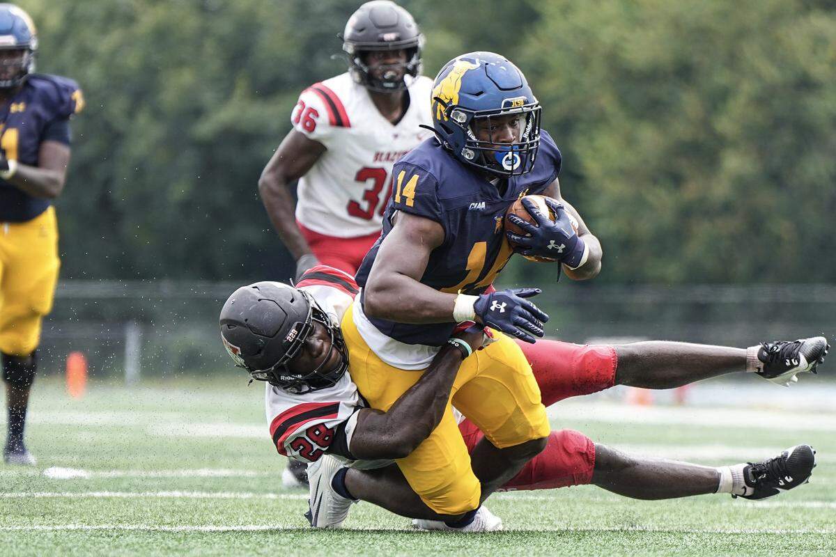 Johnson C. Smith running back Bobby Smith (14) is tackled by Valdosta State linebacker Julius Pascal (28) during the second half of a CIAA football game Saturday, Sept. 6, 2025, in Charlotte, N.C.