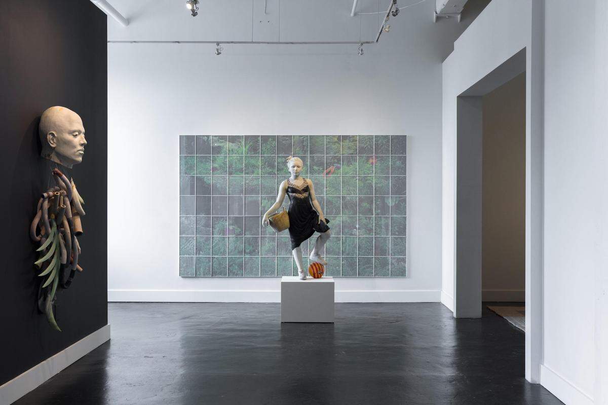Artist Cristina Córdova hung large photographs behind some of her full-scale ceramic sculptures on exhibit at Hodges Taylor gallery. This forces the figure into an environment and gives it context, she said. The “Cuerpo Exquisito” exhibition includes 11 new works by Córdova.