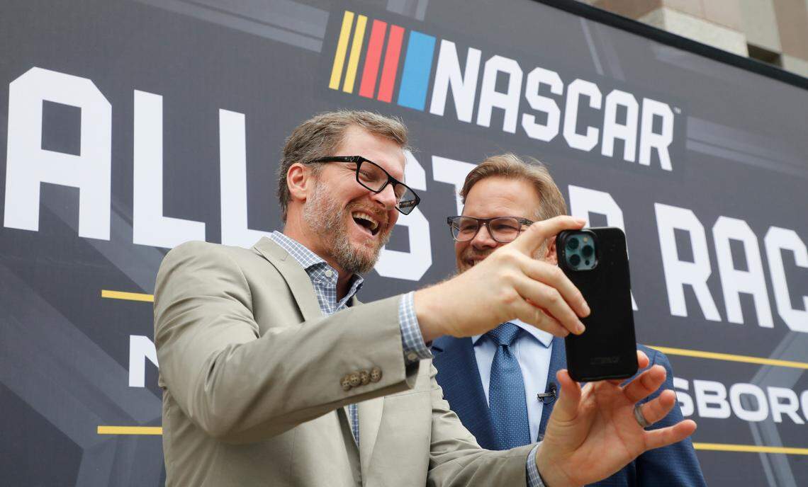 Dale Earnhardt Jr. laughs with Speedway Motorsports President and CEO Marcus Smith as they record a video after press conference announcing that the NASCAR All-Star Race will be held at North Wilkesboro Speedway in May 2023. The press conference was held on the steps of the N.C. Museum of History in Raleigh, N.C., Thursday, Sept. 8, 2022.