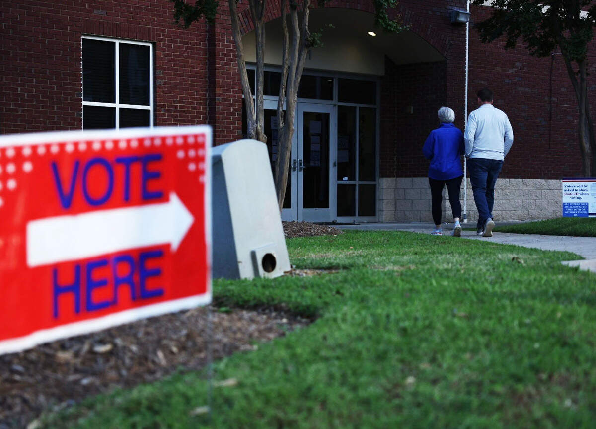 People walk into precinct 22 at the Warren McKissick Mutipurpose Center to vote in the primary election in Charlotte on Tuesday.