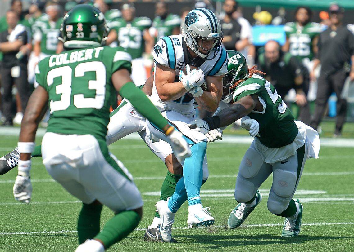 Carolina Panthers running back Christian McCaffrey fights to break through the New York Jets defense on a run during second quarter action at Bank of America Stadium in Charlotte, NC on Sunday, September 12, 2021. The Panthers defeated the Jets 19-14.