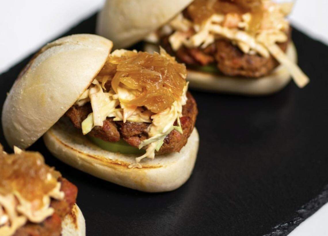 Capicúa’s Chimi sliders: Bite sized sandwiches filled with dominican sausage and ground beef, slaw and marmalade.