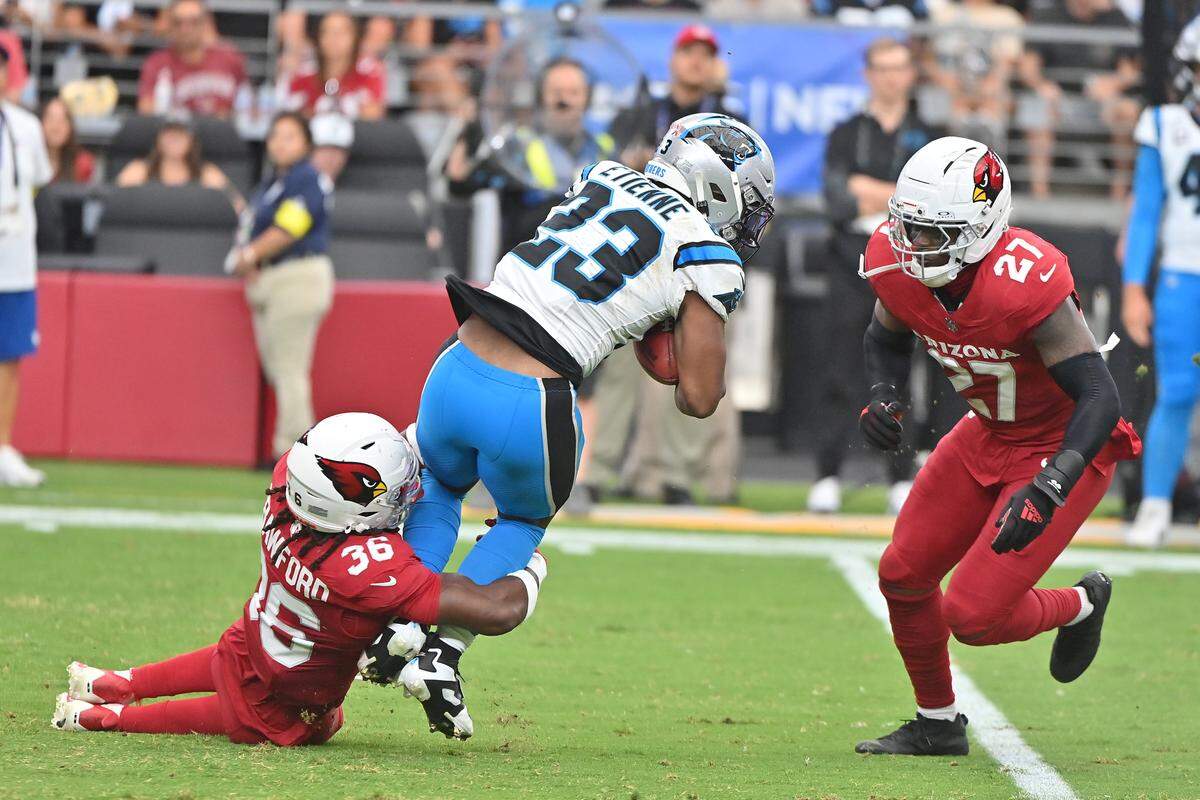Arizona Cardinals safety Kitan Crawford (36) tackles Carolina Panthers running back Trevor Etienne (23) during Sunday’s second quarter at State Farm Stadium. 