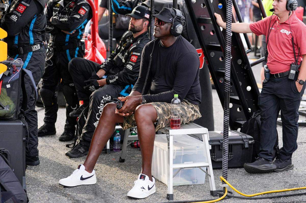 Apr 6, 2025; Darlington, South Carolina, USA; NASCAR Cup Series driver Tyler Reddick (45) team owner Michael Jordan watches his racer during the Goodyear 400 at Darlington Raceway.