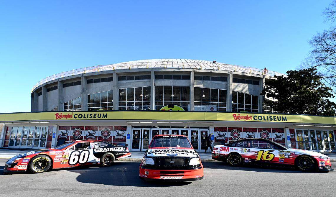 Two of former NASCAR driver Greg Biffle’s race cars and a truck series truck sit outside Bojangles Coliseum on Friday during a Gathering in Remembrance in Charlotte to honor the lives lost in the Dec. 18, 2025 plane crash in Statesville that included Biffle. 