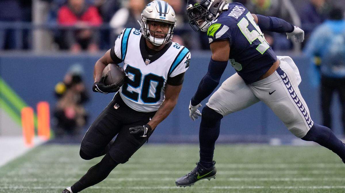 Carolina Panthers running back Raheem Blackshear (20) runs past Seattle Seahawks linebacker Jordyn Brooks (56) during the first half of an NFL football game, Sunday, Dec. 11, 2022, in Seattle. (AP Photo/Gregory Bull)