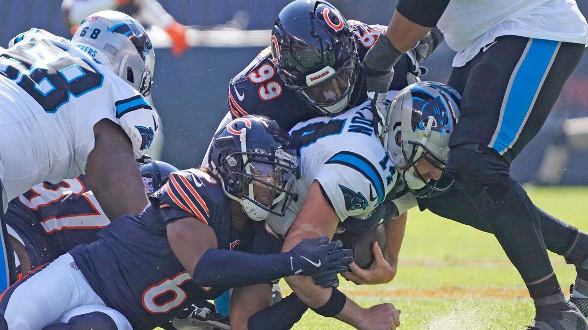 Chicago Bears cornerback Kyler Gordon (6) and defensive tackle Gervon Dexter Sr. (99) sack Carolina Panthers quarterback Andy Dalton (14) during Sunday’s first half at Soldier Field.