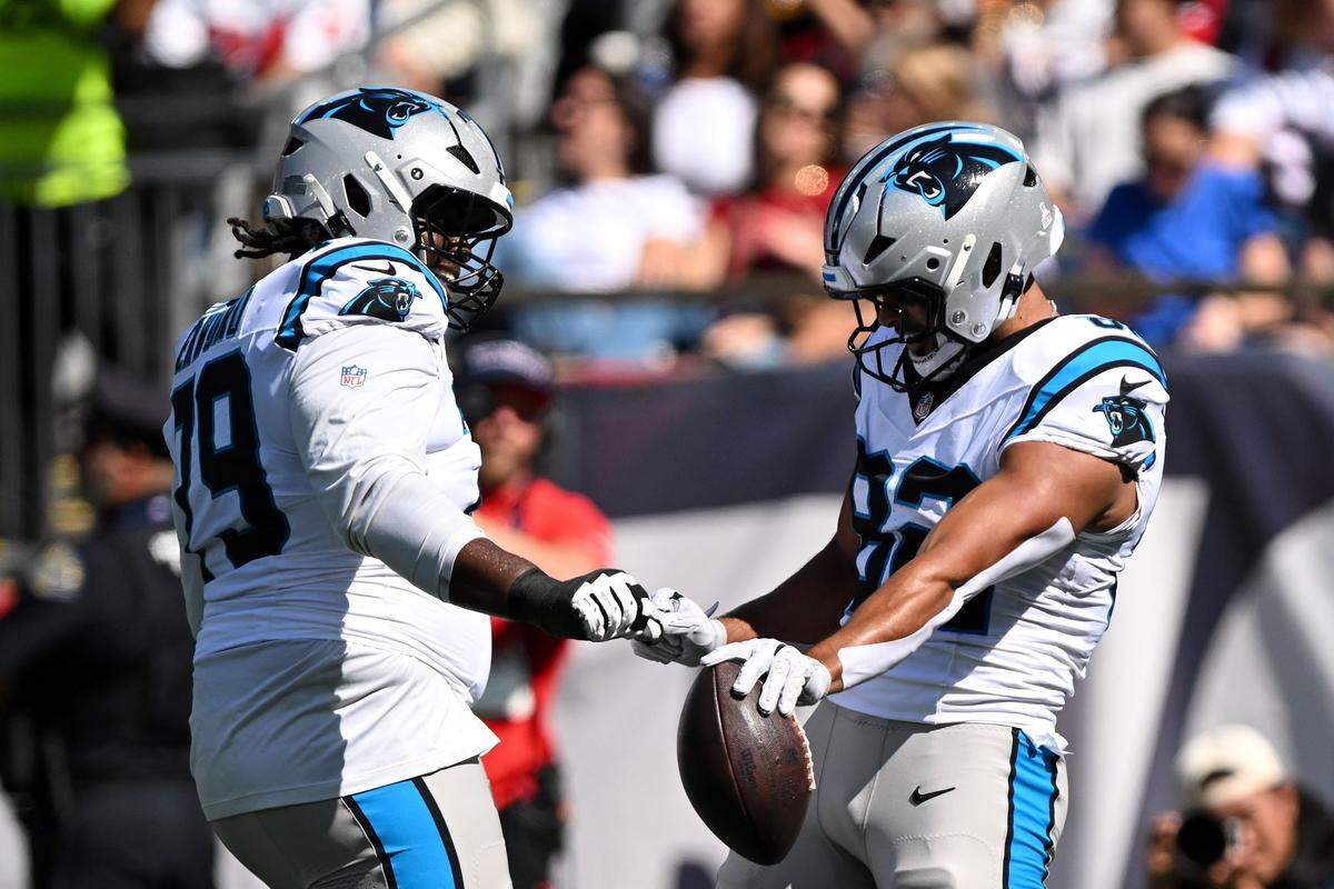 Carolina Panthers tight end Tommy Tremble (82) celebrates with offensive tackle Ikem Ekwonu (79) after scoring a touchdown against the New England Patriots on Sunday.
