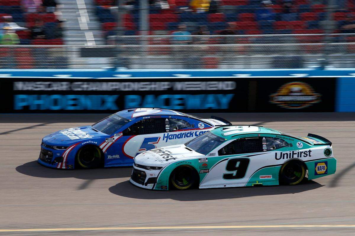 Kyle Larson (5) and Chase Elliott (9) race through Turn 4 during a NASCAR Cup Series auto race at Phoenix Raceway, Sunday, March 14, 2021, in Avondale, Ariz. (AP Photo/Ralph Freso)