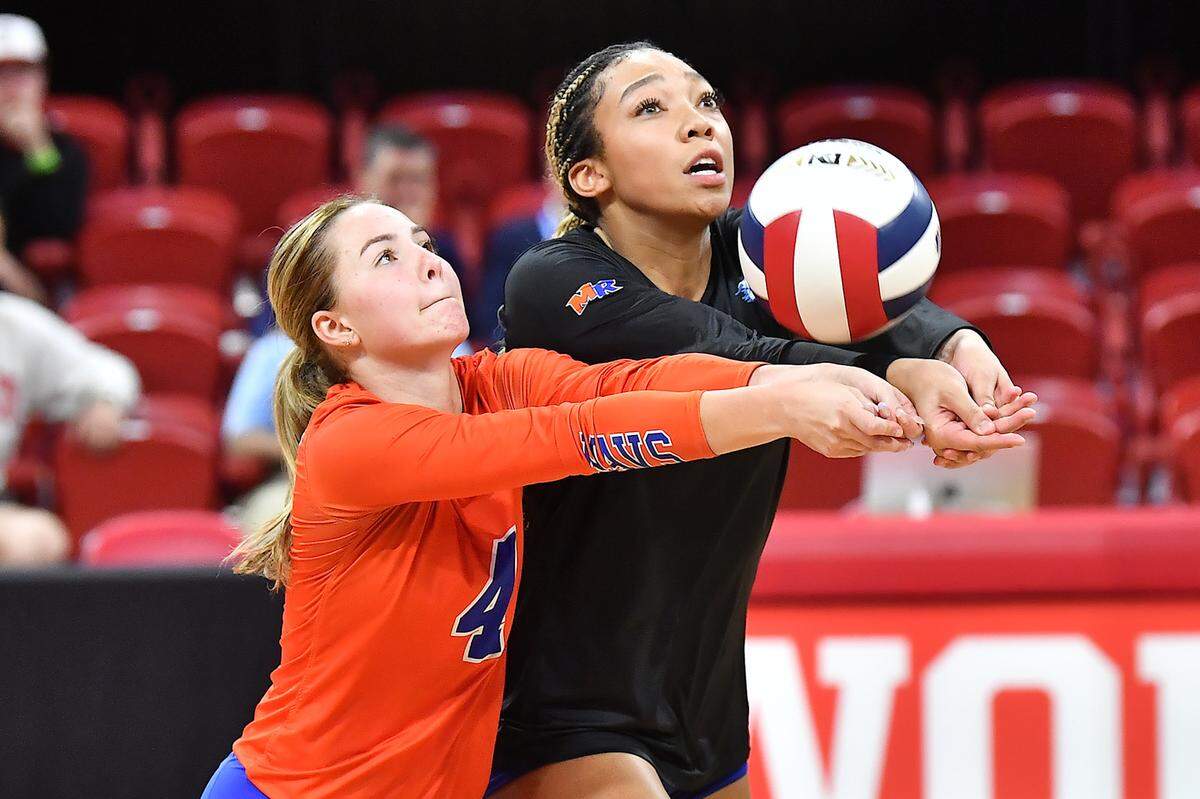 Marvin Ridge’s Victoria Simons (20) digs and returns the ball with Isabella Perkins (4) against Cardinal Gibbons in the NCHSAA 4A Volleyball Championship game. The Marvin Ridge Mavericks took on the Cardinal Gibbons Crusaders in the NCHSAA 4A Volleyball Championship match in Raleigh, N.C. on November 2, 2024.