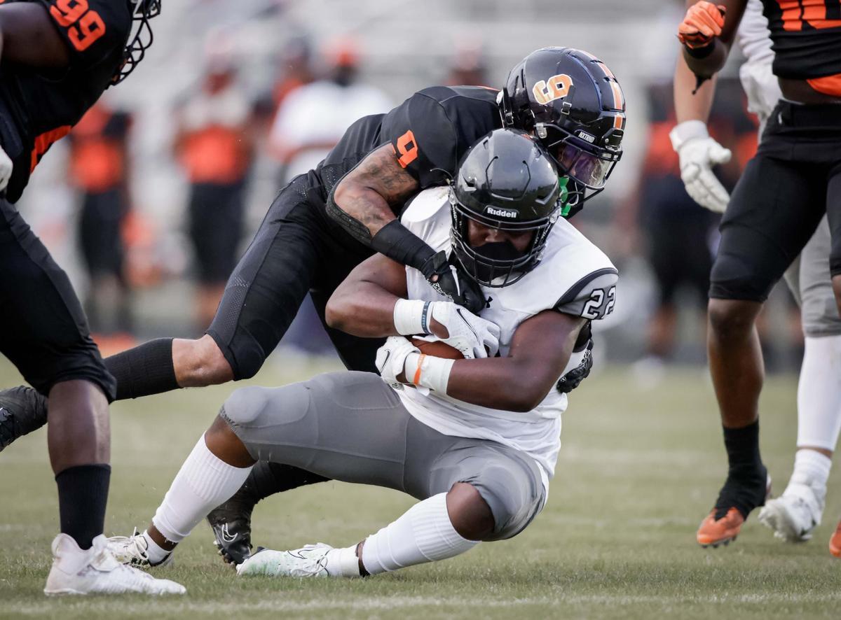 Vance Cougar Avarion Cole (9) gets the tackle. Hough Huskie Jacquon Gibson (10) catches the deep pass for the 1st down. The Hough Huskies win the I-MECK 4A championship 29-22 vs the Vance Cougars Friday April 9, 2021.