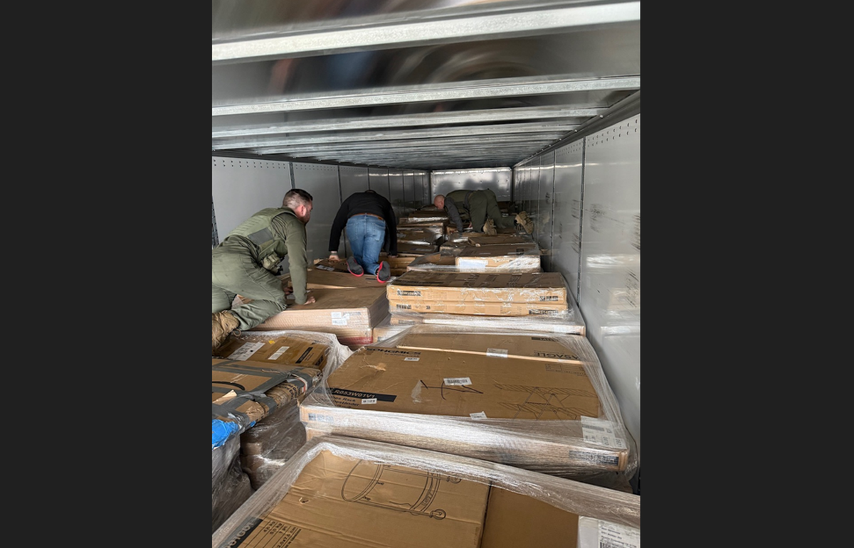 Photos show the stacks of cash were well disguised among other boxes in the trailer, but a drug-sniffing K-9 was not fooled, officials said.