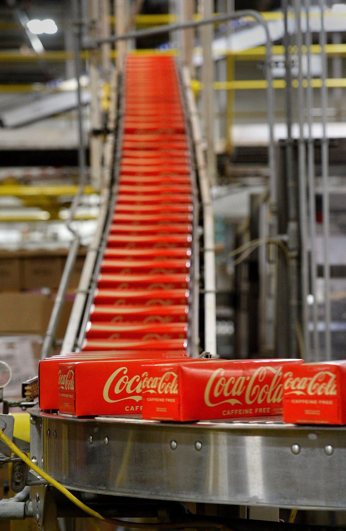 Boxed 12-packs of Coca-Cola roll of the line at the Coca-Cola Consolidated distribution center.