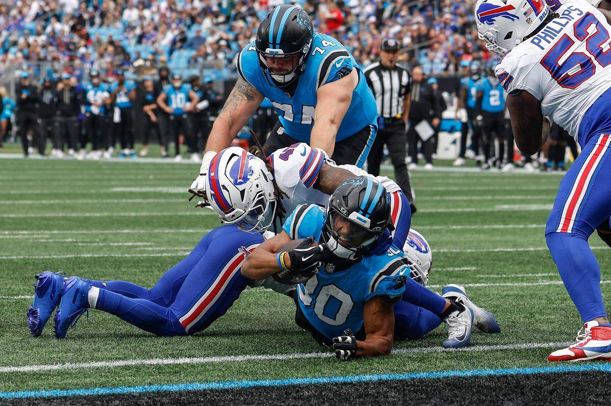 Panthers running back Chuba Hubbard crosses the threshold of the end zone for a touchdown as Bills linebacker Shaq Thompson defends during the game at Bank of America Stadium in Charlotte, NC on Sunday, October 26, 2025.