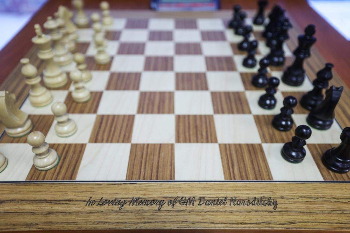 An engraved chess board at the Charlotte Chess Center honors the late Daniel Naroditsky.