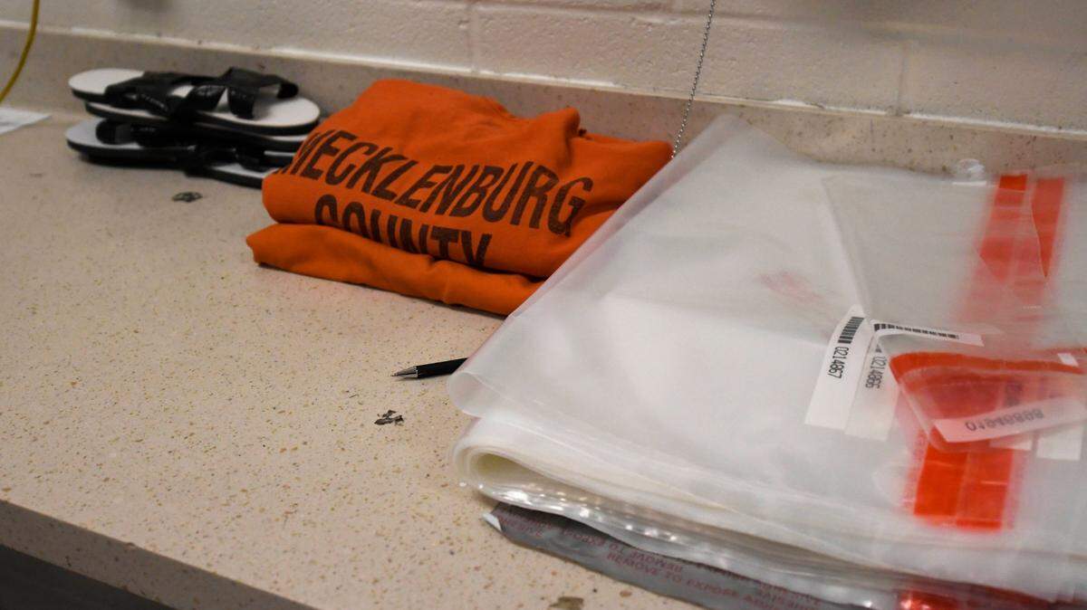 Mecklenburg County Sheriff’s Department detention uniforms are stacked at an intake area at Jail Central on Saturday, March 16, 2019.