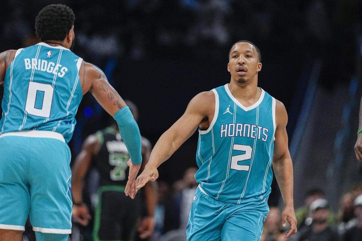Charlotte Hornets forward Grant Williams (2) and forward Miles Bridges (0) react to his three pointer during the second quarter against the Boston Celtics at the Spectrum Center. 