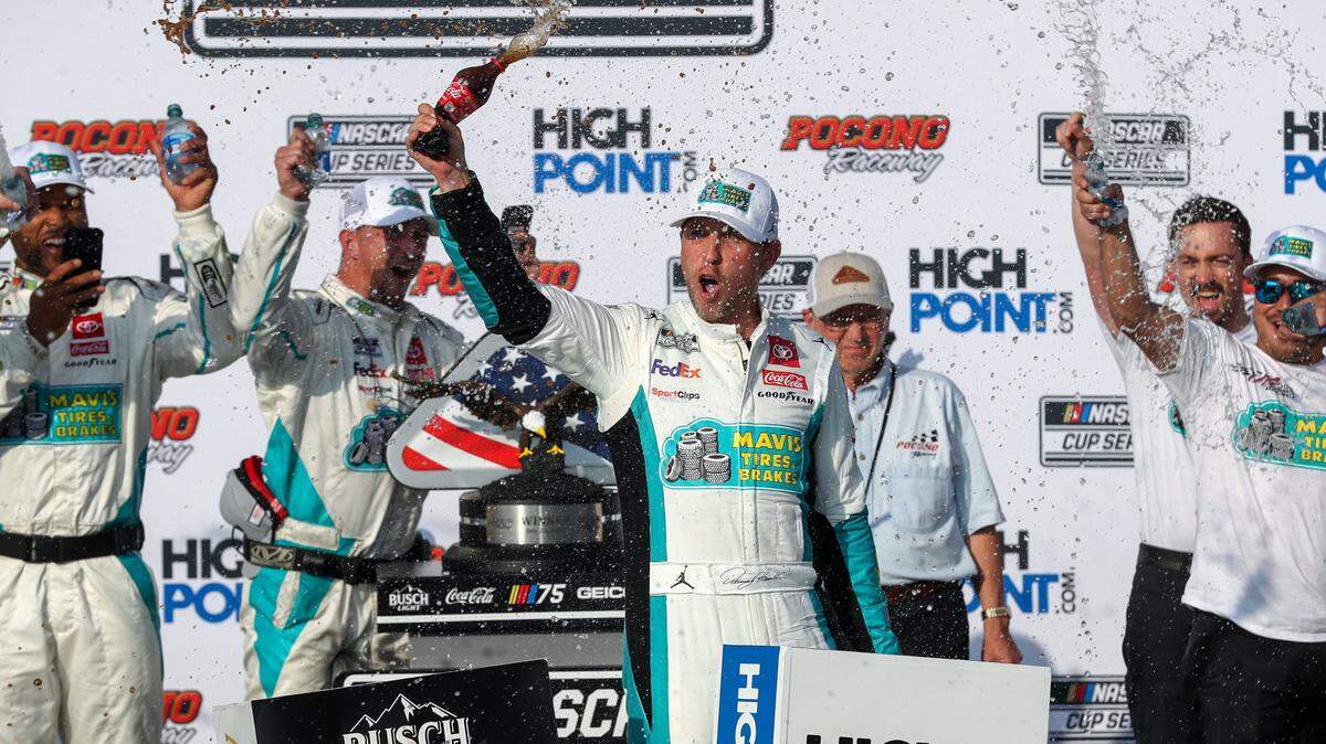 NASCAR Cup Series driver Denny Hamlin celebrates in victory lane after winning the HighPoint.com 400 at Pocono Raceway.