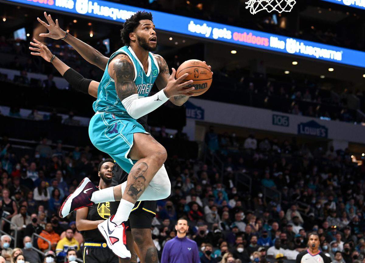 Charlotte Hornets forward Miles Bridges drives to the basket for a shot against the Golden State Warriors during first half action at Spectrum Center in Charlotte, NC on Sunday, November 14, 2021.