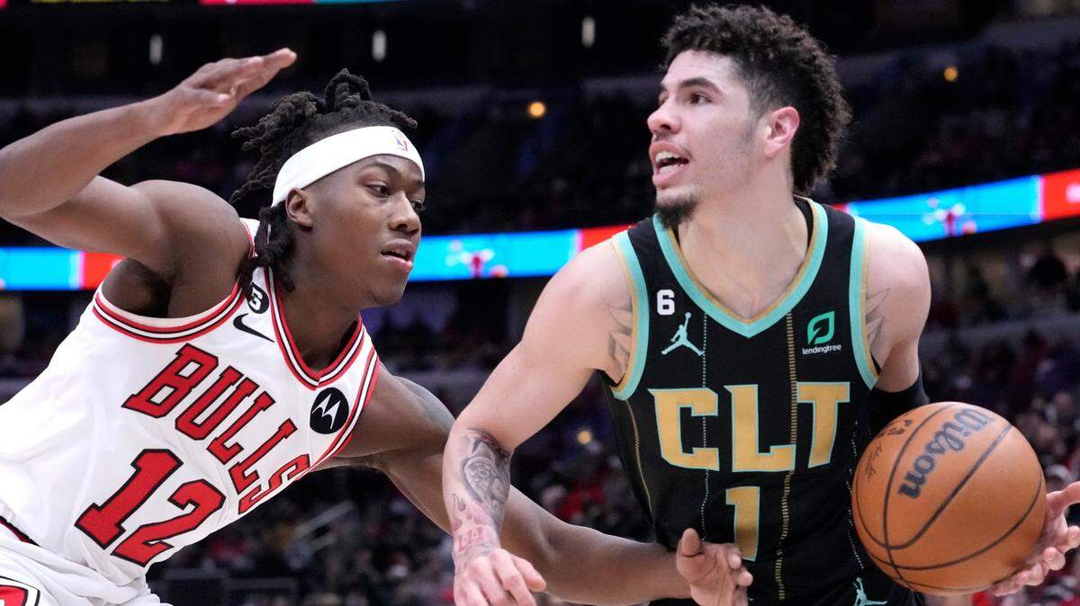 Charlotte Hornets’ LaMelo Ball, right, looks to pass as Chicago Bulls’ Ayo Dosunmu defends during the first half of an NBA basketball game Thursday, Feb. 2, 2023, in Chicago. (AP Photo/Charles Rex Arbogast)