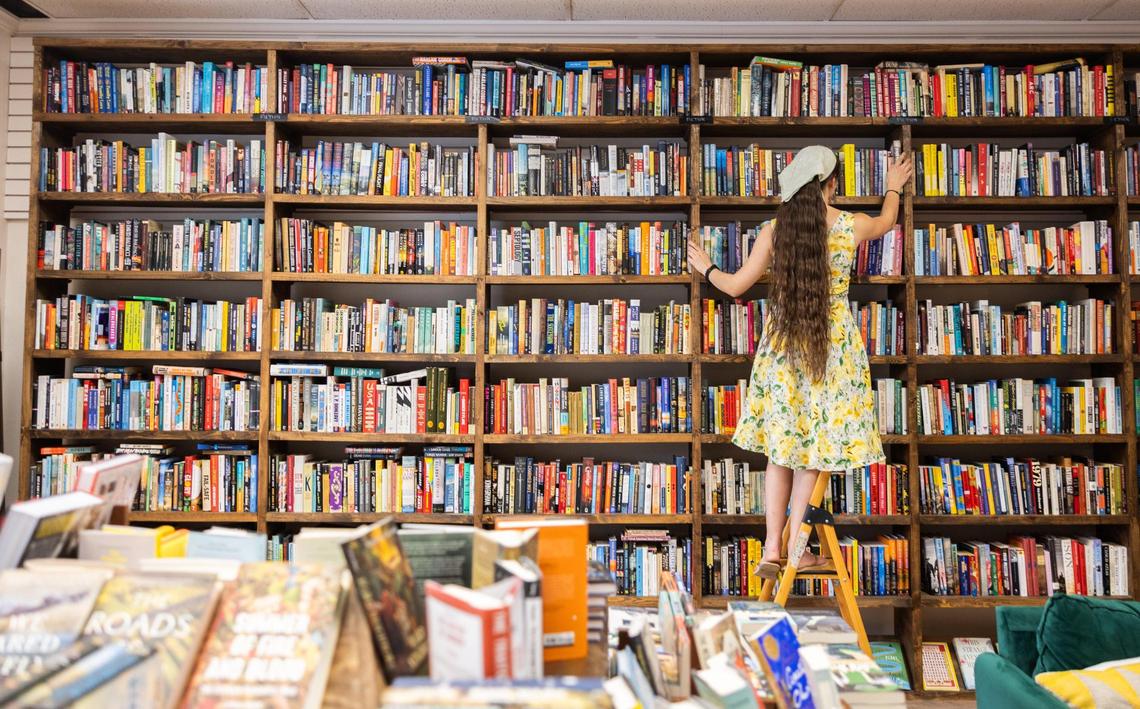 Judah Davis organizes books at Goldberry Books in Concord during the Greater Charlotte Book Crawl. Davis said business has definitely increased for the local shop that faced difficulties in the last few years due to construction.