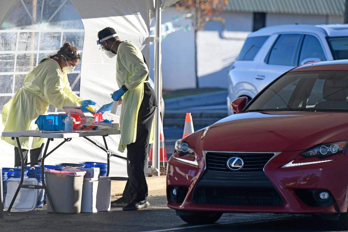 Medical personnel process drive-thru COVID-19 testing at StarMed Family & Urgent Care on Nov. 17, 2020. Mecklenburg recorded a record-breaking number of new COVID-19 cases on Sunday as the county quickly approaches peak levels of coronavirus spread.