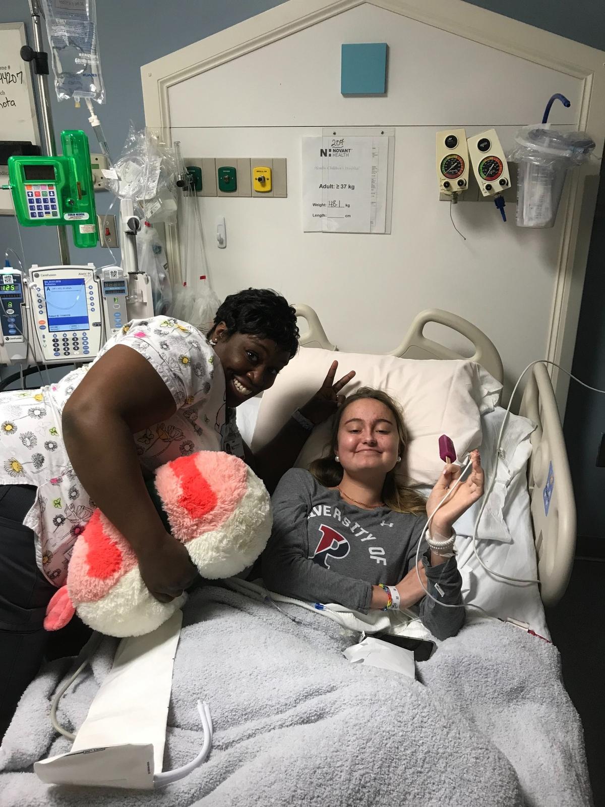 Jane Harrell — photographed here with one of her nurse's assistants the week she was diagnosed with DIPG — did a surprising amount of smiling and laughing during her time at Levine Children's Hospital, her family says.