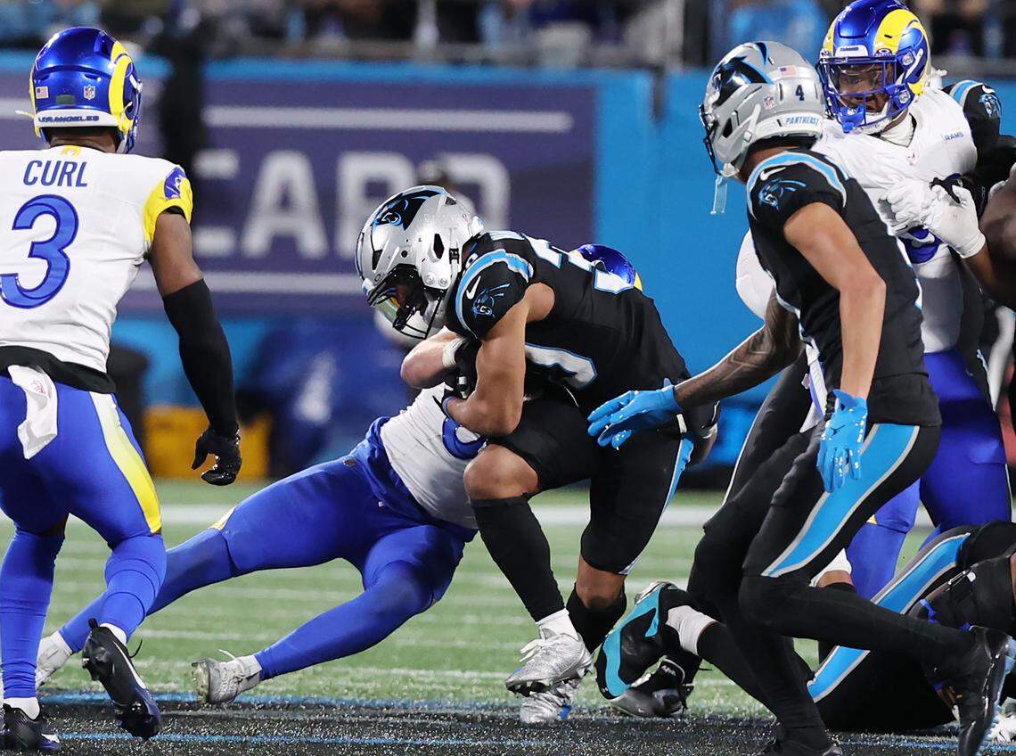 Carolina Panthers running back Chuba Hubbard is tackled by Los Angeles Rams inside linebacker Nate Landman during the wild card playoff game against the Rams at Bank of America Stadium on Saturday, Jan. 10, 2025 in Charlotte