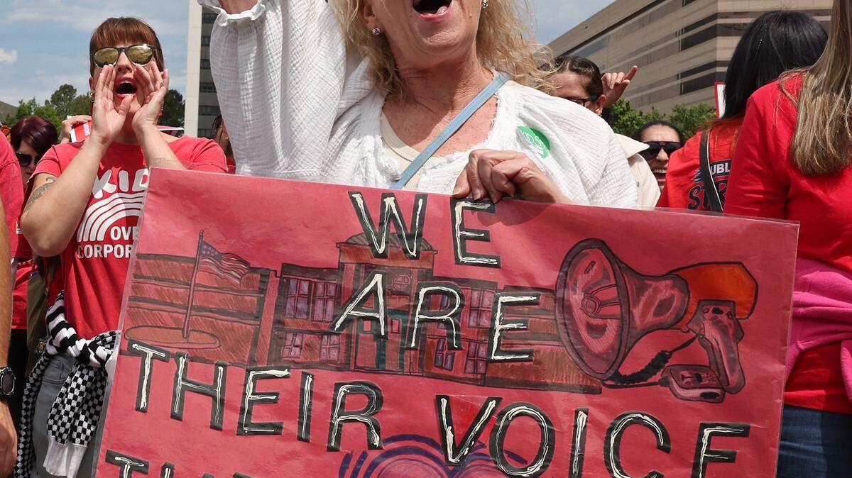 Leslie Highfill, a South Meck High K-12 special needs teacher cheers a speaker during a rally at the Government Complex in Raleigh, NC on Friday, May 1, 2026. Teachers rallied and marched through downtown Raleigh, NC to protest the need for more funding for public schools. 