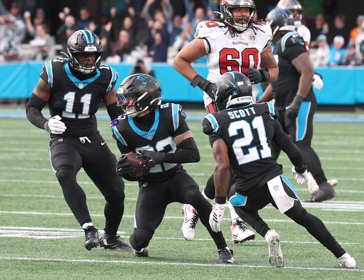 Carolina Panthers safety Lathan Ransom, center, intercepts a pass by Tampa Bay Buccaneers quarterback Baker Mayfield during action on Sunday, December 21, 2025 at Bank of America Stadium in Charlotte, NC. The Panthers defeated the Buccaneers 23-20.