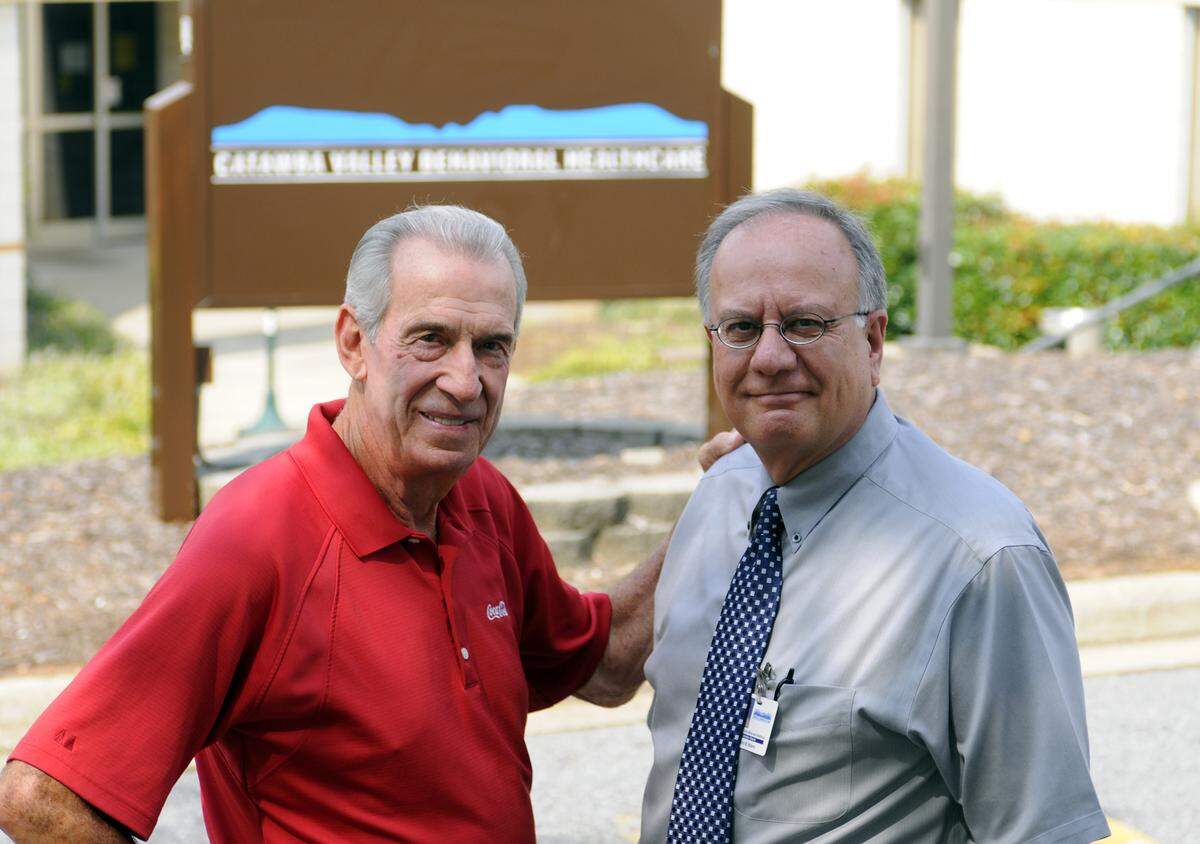 9/15/2009 - Catawba Valley Behavioral Healthcare director John Waters (right) and NASCAR legend Ned Jarrett (left) at the offices of Catawba Valley Behavioral Healthcare in Hickory.  The non-profit agency must move out of it's current offices and is looking for a new building, and having to deal with deep budget cuts.  Ned Jarrett has agreed to chair a fund drive that hopes to raise $500,000.00 this Fall.      JEFF WILLHELM - jwillhelm@charlotteobserver.com