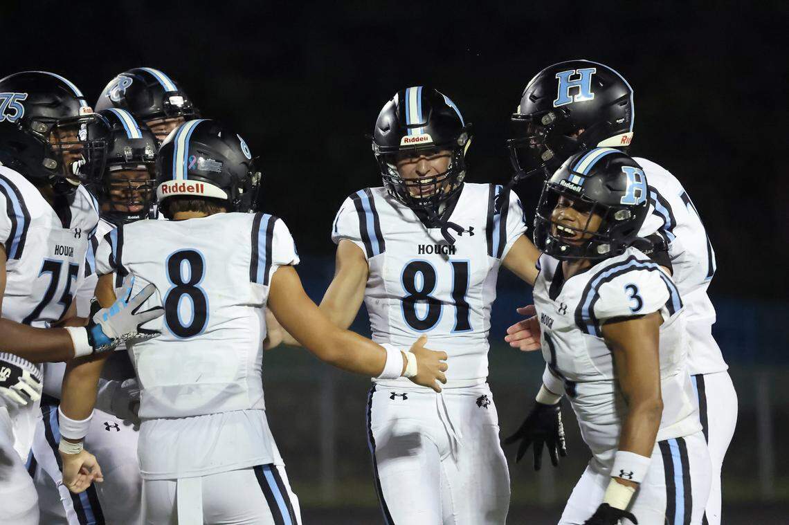 Hough Huskies kicker Nolan Hauser, center, is mobbed by his teammates following his national record breaking kick during third quarter action against the North Meck Vikings on Thursday, September 14, 2023 at North Meck High School. Hauser kicked his 57th career field goal.