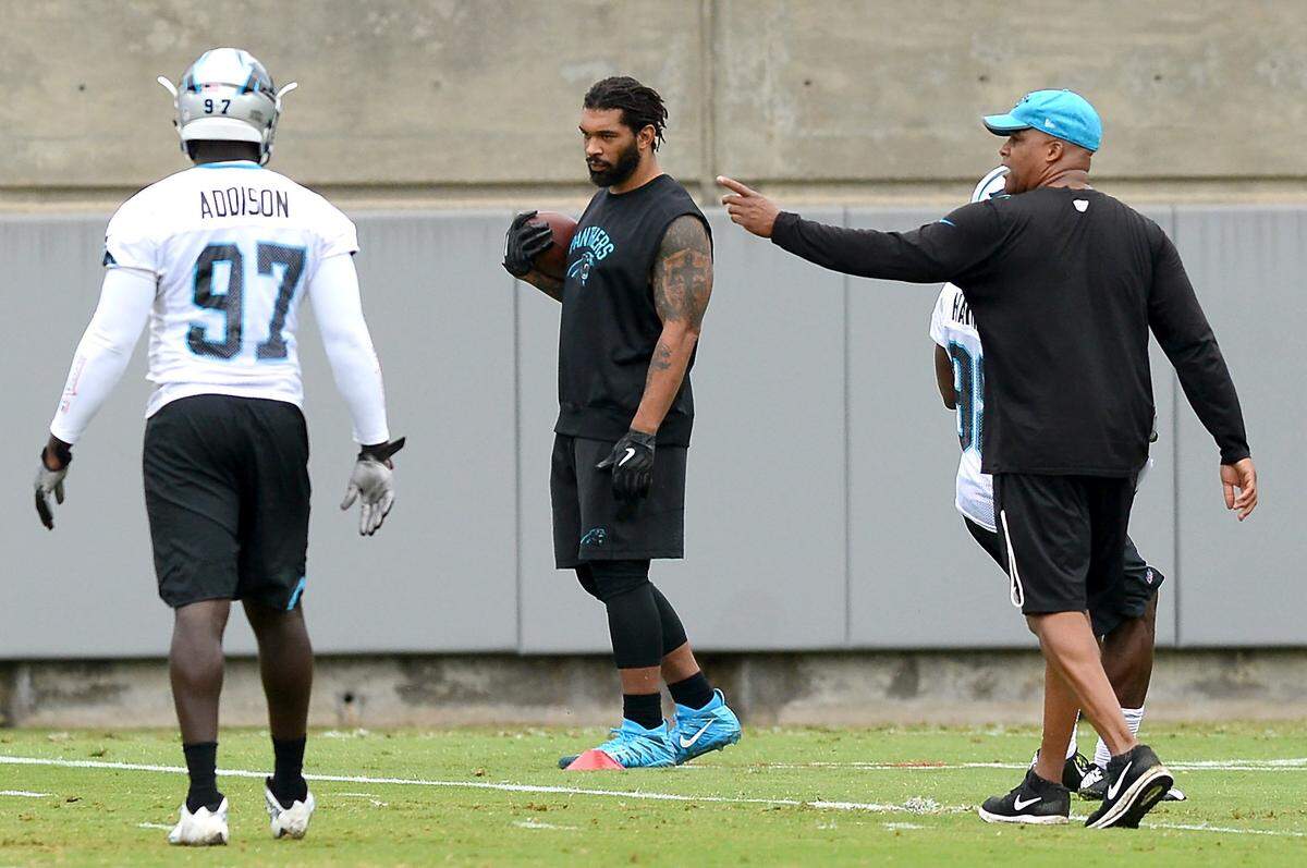 Carolina Panthers defensive end Julius Peppers, center, cradles a football while watching his teammates run through drills at practice on Tuesday, June 12, 2018.The Panthers started their minicamp on Tuesday morning. 