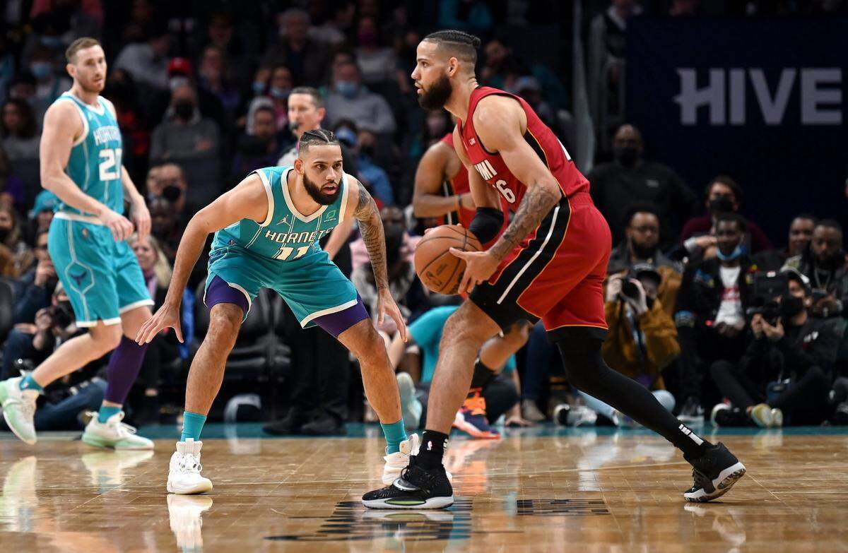 Charlotte Hornets forward Cody Martin, left, guards his brother, Miami Heat forward Caleb Martin, right, during first half action on Saturday, February 5, 2022 at Spectrum Center in Charlotte, NC.