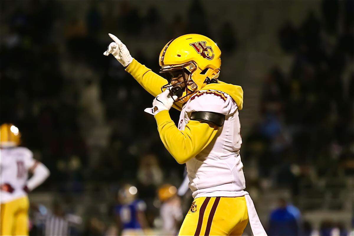 West Charlotte KD Cotton points to the field as his team gets possesion of the ball at the West Charlotte Dudley NCHSAA playoff game at Dudley high school in Greensboro NC on December 6, 2024