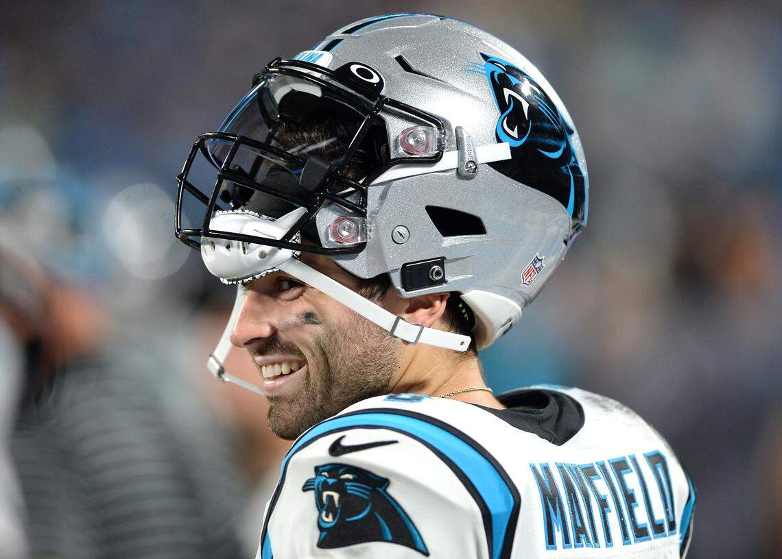 Carolina Panthers quarterback Baker Mayfield smiles as he walks along the team’s sideline during action against the Buffalo Bills at Bank of America Stadium in Charlotte, NC on Friday, August 26, 2022.