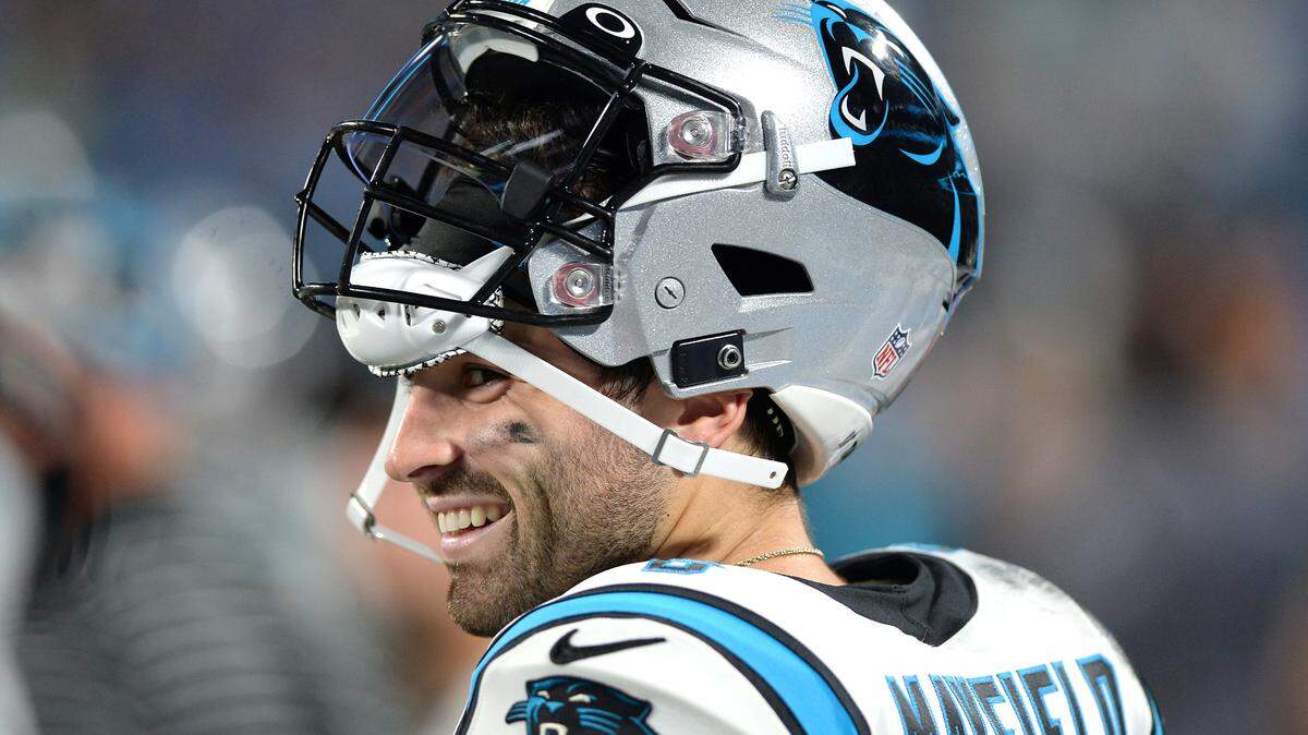 Carolina Panthers quarterback Baker Mayfield smiles as he walks along the team’s sideline during action against the Buffalo Bills at Bank of America Stadium in Charlotte, NC on Friday, August 26, 2022.