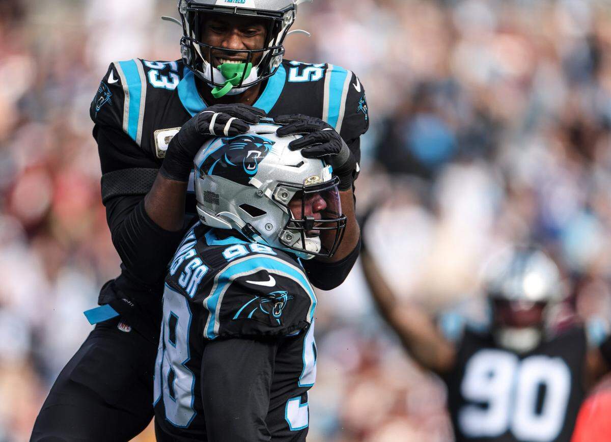 Carolina Panthers Brian Burns, top, celebrates with Marquis Haynes Sr. after a sack against the Washington Football Team at the Bank of America Stadium in Charlotte, N.C., on Sunday, November 21, 2021.