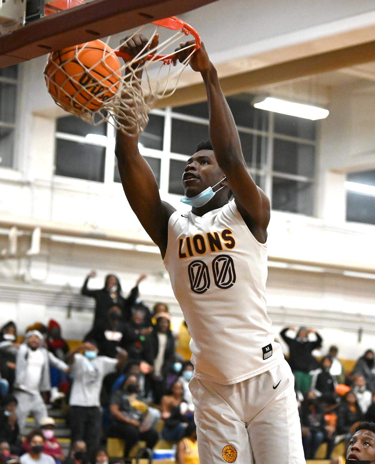 West Charlotte Lions Donovon Raymond throws down a two-handed dunk during first half action against North Meck on Friday, January 14, 2022 at West Charlotte High School.