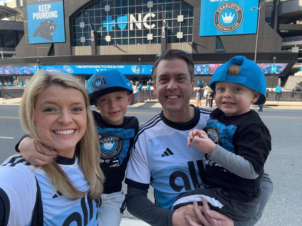Mary King with 6-year-old Jaxon, husband Curtis, and 2-year-old Luke, photographed outside of Bank of America Stadium last month.