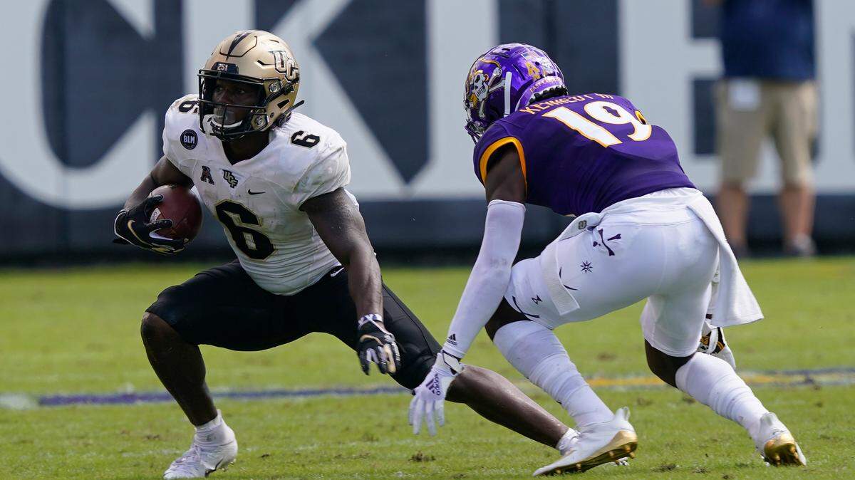 East Carolina defensive back Robert Kennedy (19) looks to tackle Central Florida wide receiver Marlon Williams (6) during the first half of an NCAA college football game in Greenville, N.C., Saturday, Sept. 26, 2020. (AP Photo/Gerry Broome)