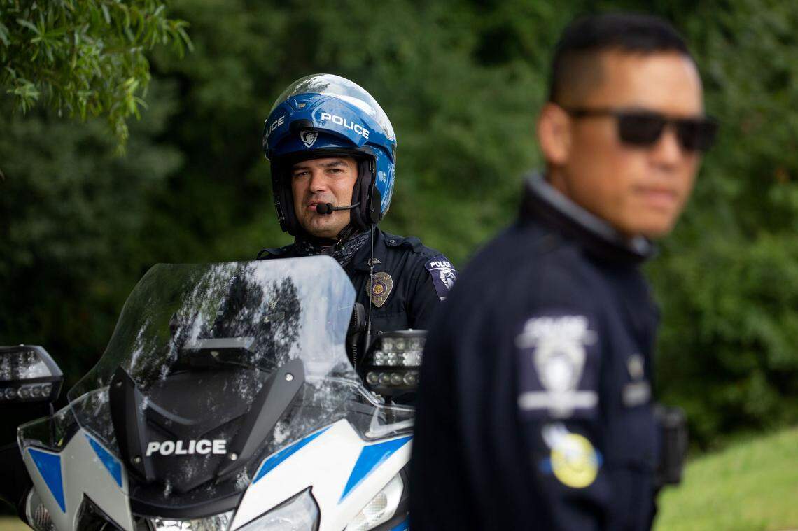 Sgt. Adam Jones, left, and Officer Danny Leung, right, check for motorists driving over the speed limit on Freedom Drive.