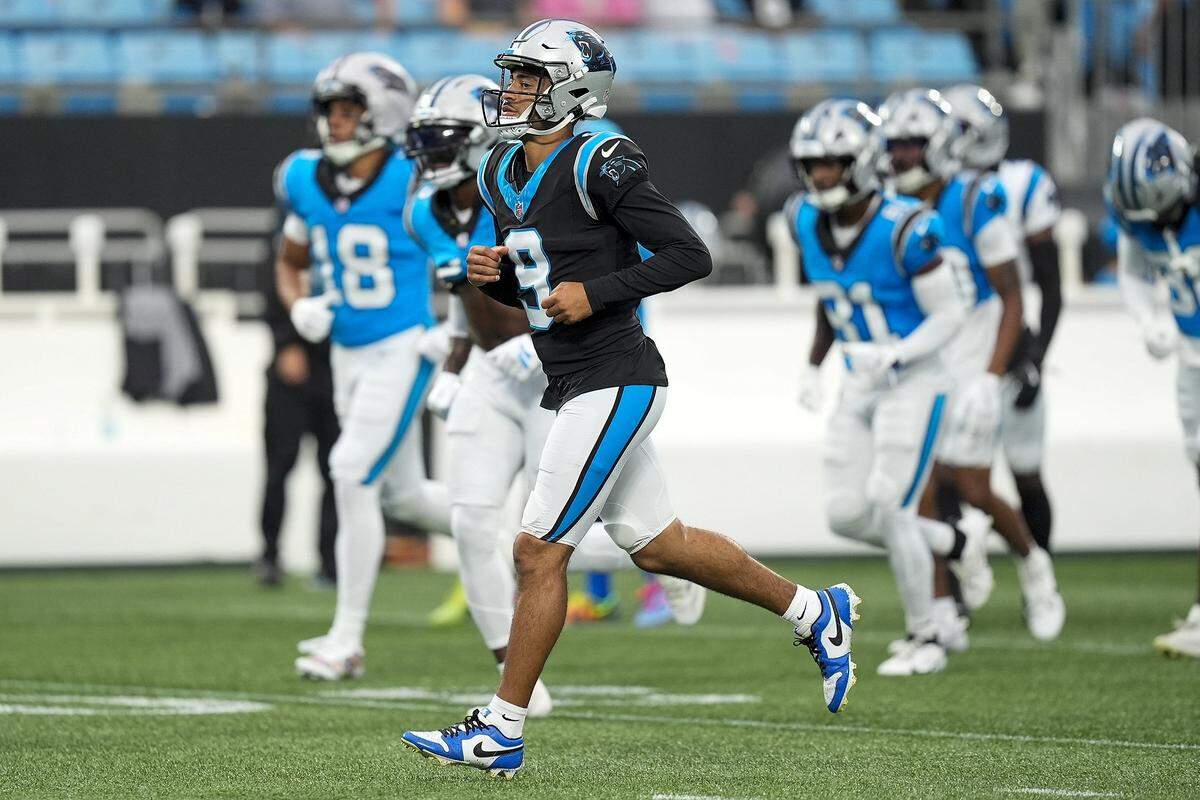 Aug 2, 2025; Charlottle, NC, USA; Carolina Panthers quarterback Bryce Young (9) jogs to the huddleduring Fanfest at Bank of America Stadium. Mandatory Credit: Jim Dedmon-Imagn Images