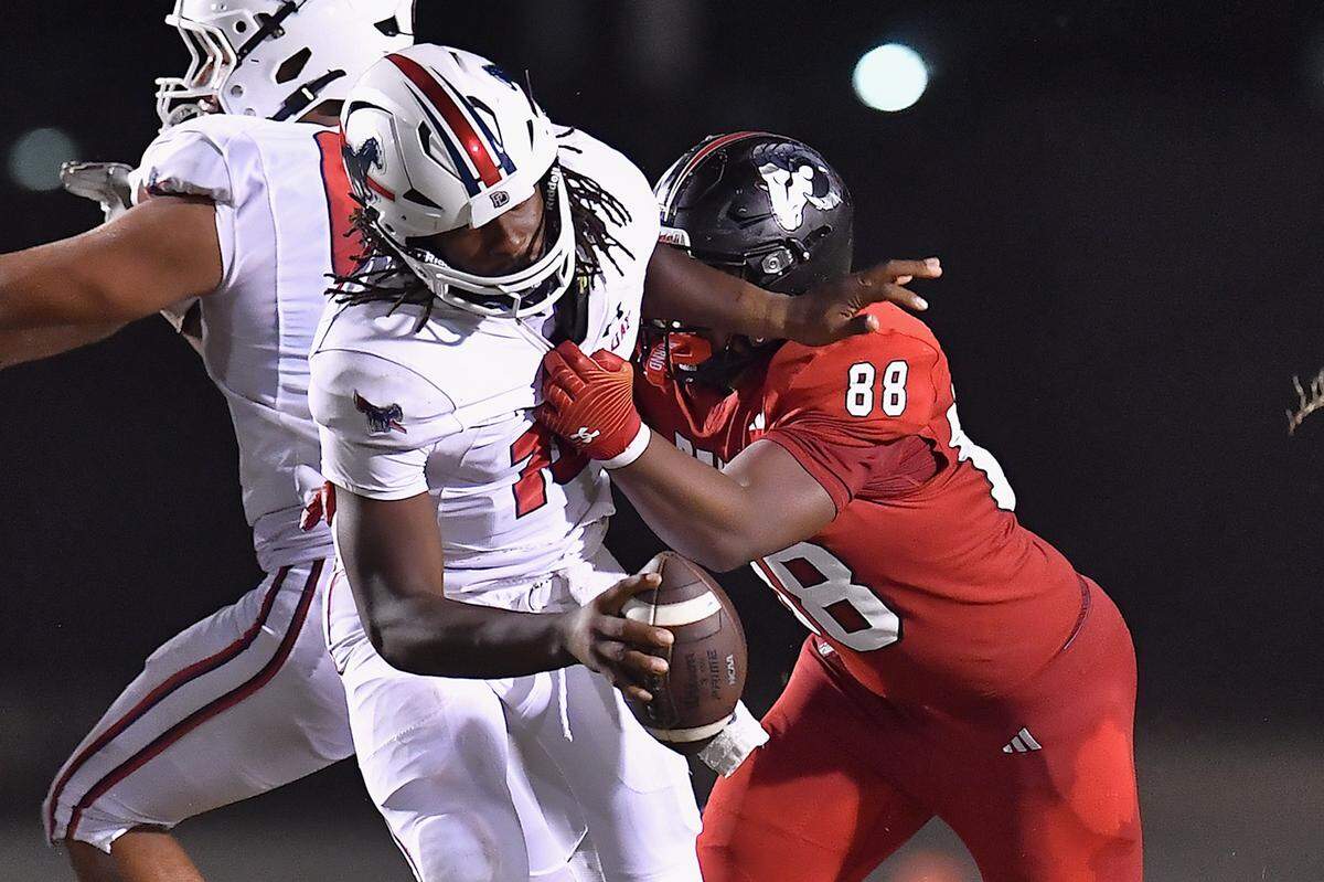Rolesville defensive lineman Malachi Harris (88) grapples and sacks Providence Day quarterback Zaid Lott (10) in the second half. The Rolesville Rams and the Providence Day Chargers met in a non-conference football game in Rolesville, N.C. on August 29, 2025.