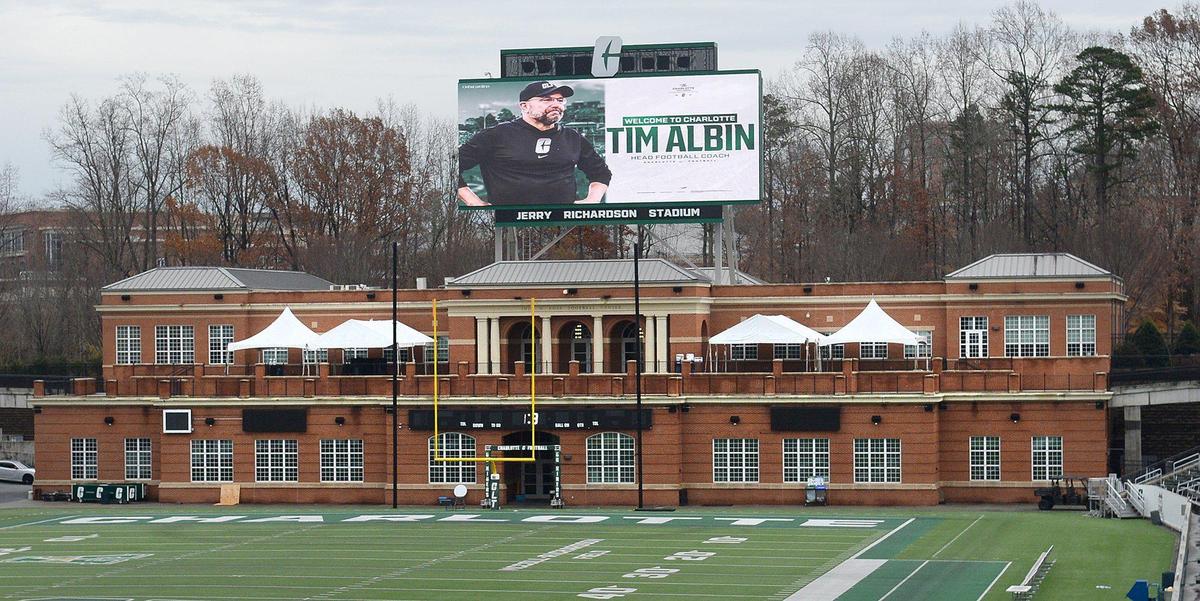 Even before the official press conference, UNC Charlotte touted their new coach Tim Albin on digital billboards at Jerry Richardson Stadium. The Charlotte 49ers officially announced Tim Albin, a two-time Mid-American Conference coach of the year, as the new head coach of their gridiron squad on Monday, Dec. 9, 2024. About 200 people attended the announcement.