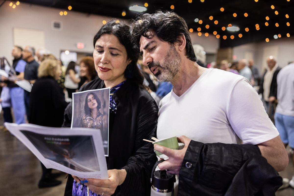 A couple sings a song of remembrance for Iranians killed during demonstrations against the Iranian government.