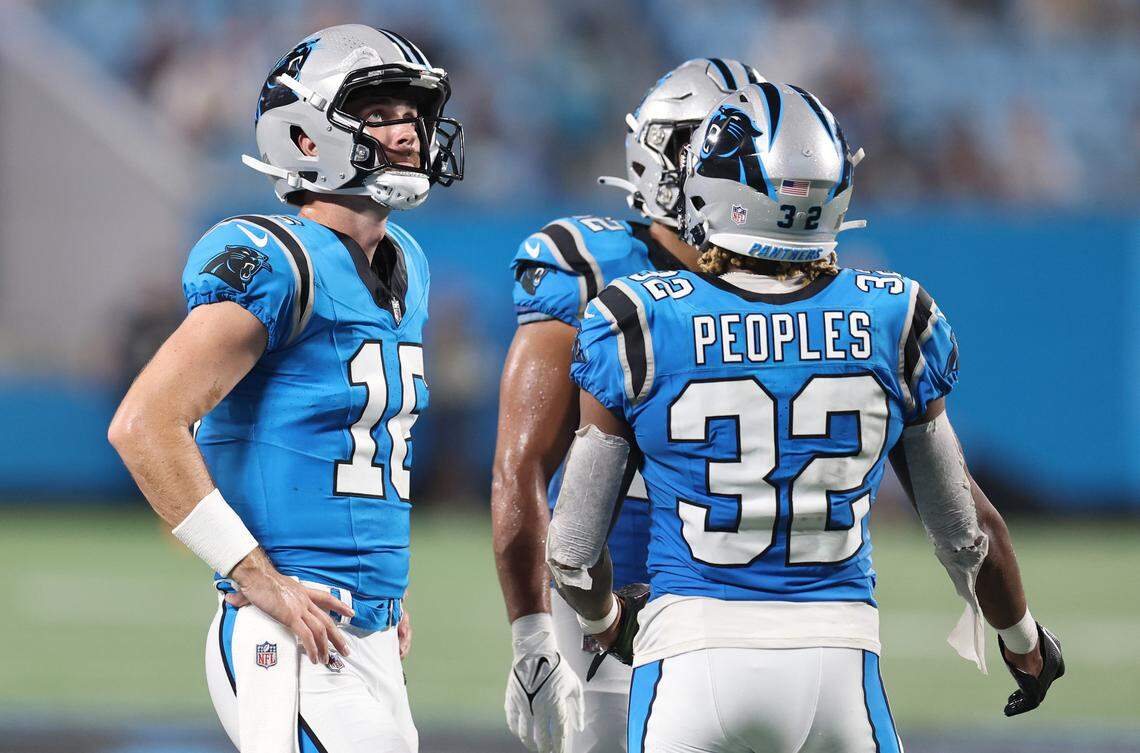 Carolina Panthers quarterback Jake Luton, left, watches a play under review during second half action against the Detroit Lions on Friday, August 25, 2023 at Bank of America Stadium in Charlotte, NC. Luton and Peoples, back to camera, were among the team’s first 11 roster cuts on Saturday, August 26, 2023.